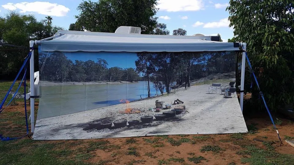 Caravan privacy screen printed with a fishing boat at anchor in calm water