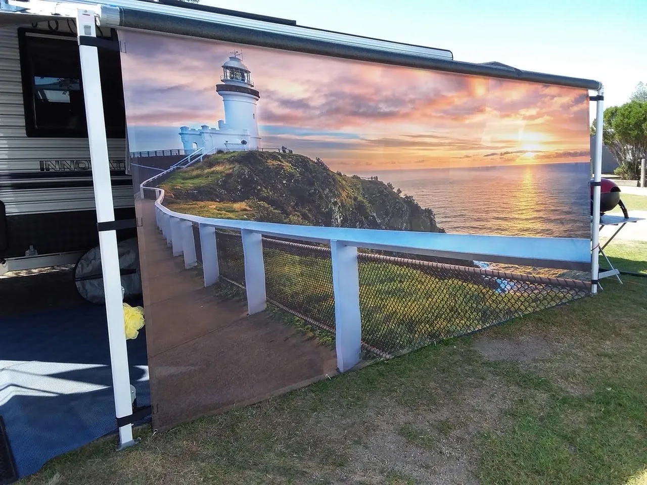 Custom privacy screen with a lighthouse at sunset